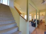 The stairs lead to the master bedroom, guest room, bathroom and study with futon